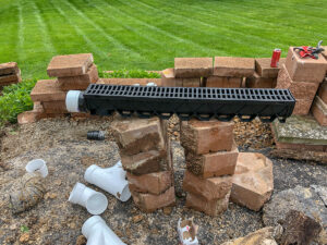 Retaining Wall and Drain Repair - Greener Designs Landscaping--Lawn-&--Construction